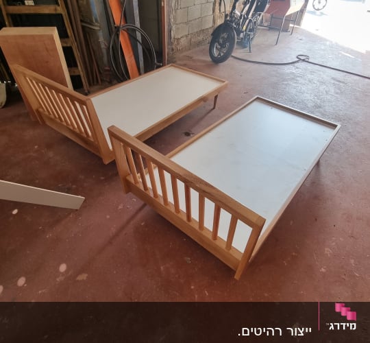 שתי מיטות עץ לא גמורות בסדנת נגרות